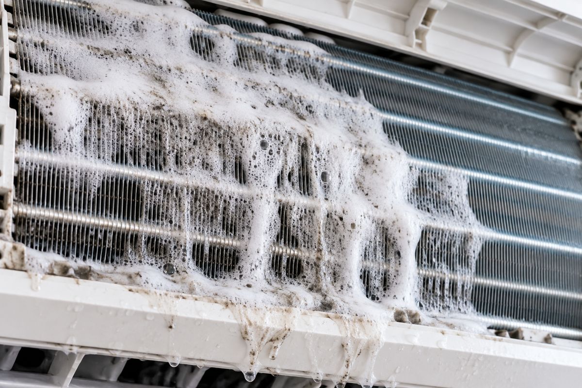 Close-up of aircon coil fins covered in foaming coil cleaner